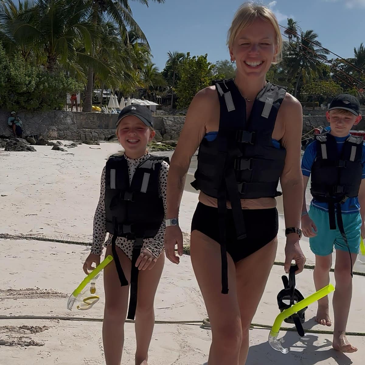 Snorkel tour group exiting the turquoise water at Akumal Bay after their sea turtle experience
